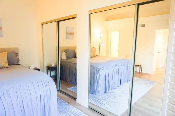 a bedroom with a bed and a mirror