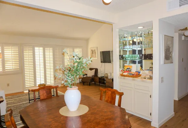 a dining room with furniture and large windows