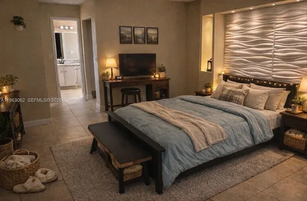 a bedroom with a bed and a flat screen tv