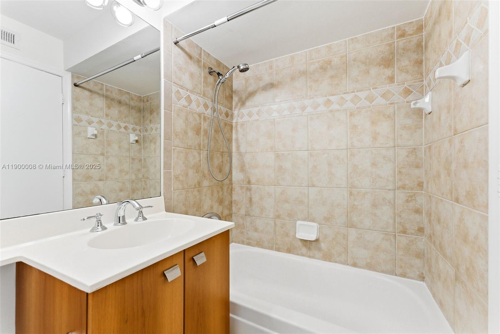 1000 Crystal Way, Unit E Delray Beach, FL 33444 - Photo 15 of 16 a bathroom with a sink mirror toilet and bathtub