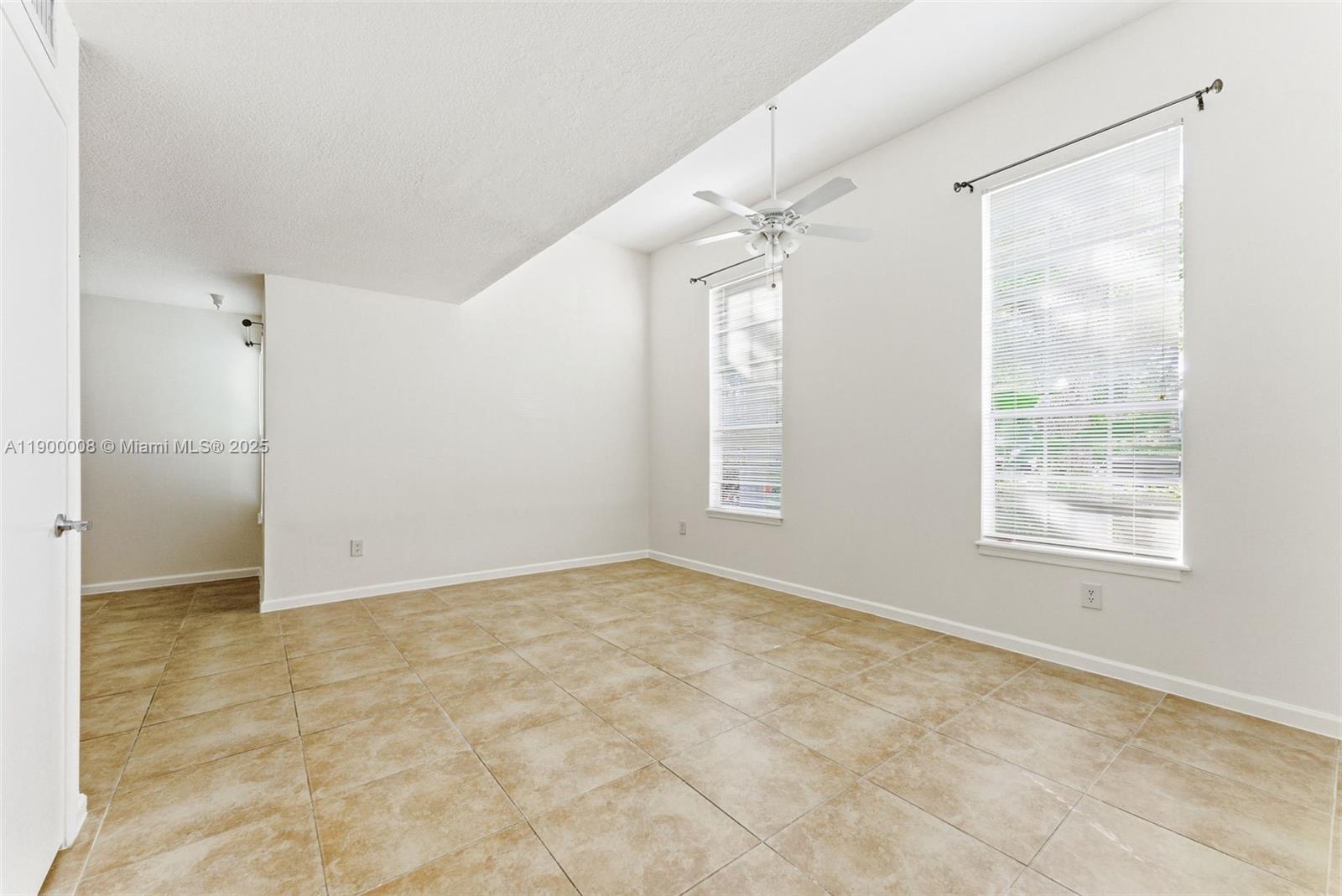 1000 Crystal Way, Unit E Delray Beach, FL 33444 - Photo 7 of 16 an empty room with windows and closet
