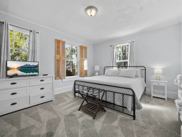 a spacious bedroom with a bed and window