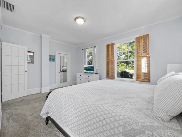 a bedroom with a large bed and a window