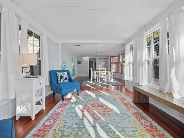a bedroom with furniture and a wooden floor