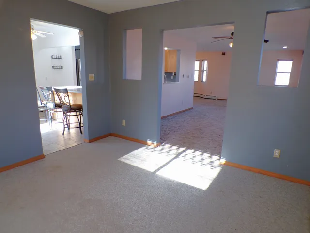 a view of a dining room with furniture and a chandelier