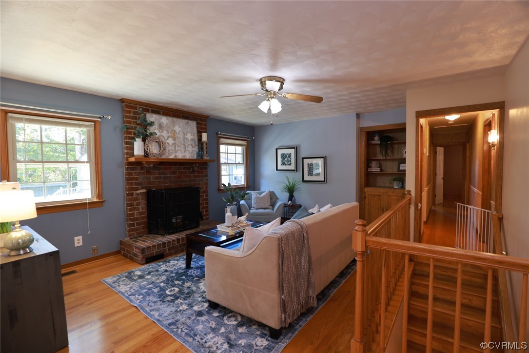 7317 Creighton Road Mechanicsville, VA 23111 - Photo 11 of 46 a living room with furniture a window and a fireplace