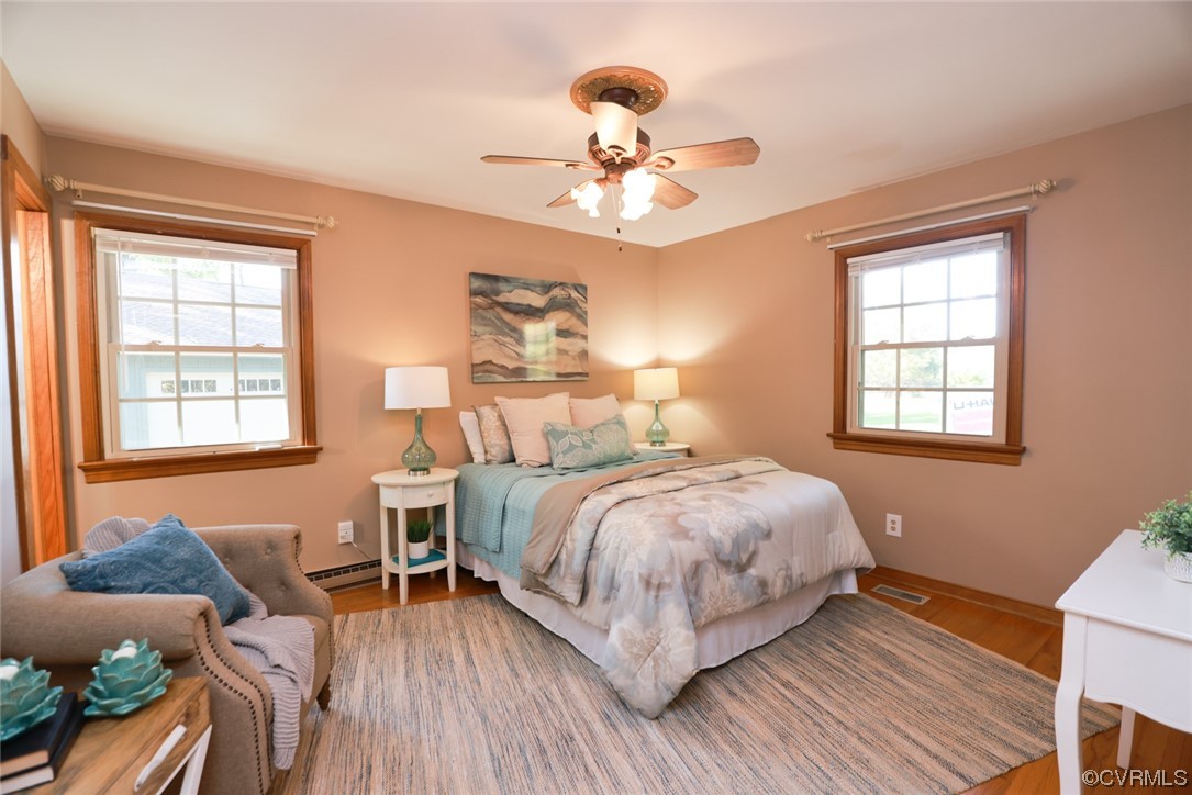 7317 Creighton Road Mechanicsville, VA 23111 - Photo 19 of 46 a bedroom with a bed and wooden floor