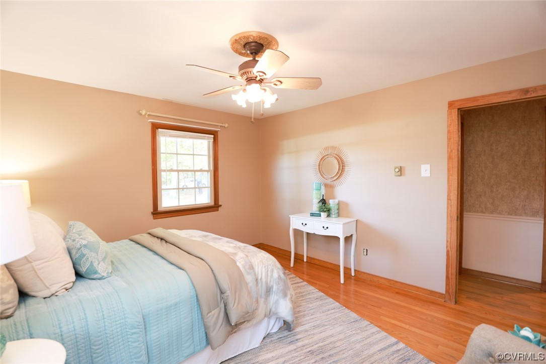 7317 Creighton Road Mechanicsville, VA 23111 - Photo 21 of 46 a bedroom with a bed and a chandelier