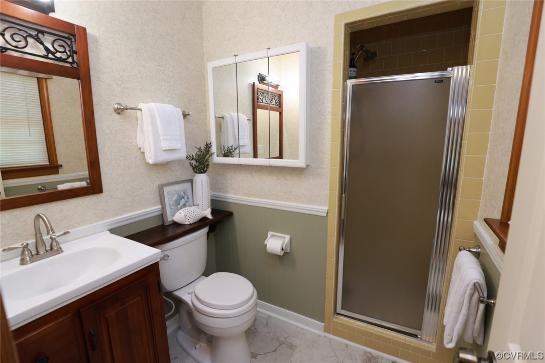 7317 Creighton Road Mechanicsville, VA 23111 - Photo 22 of 46 a bathroom with a toilet sink and mirror