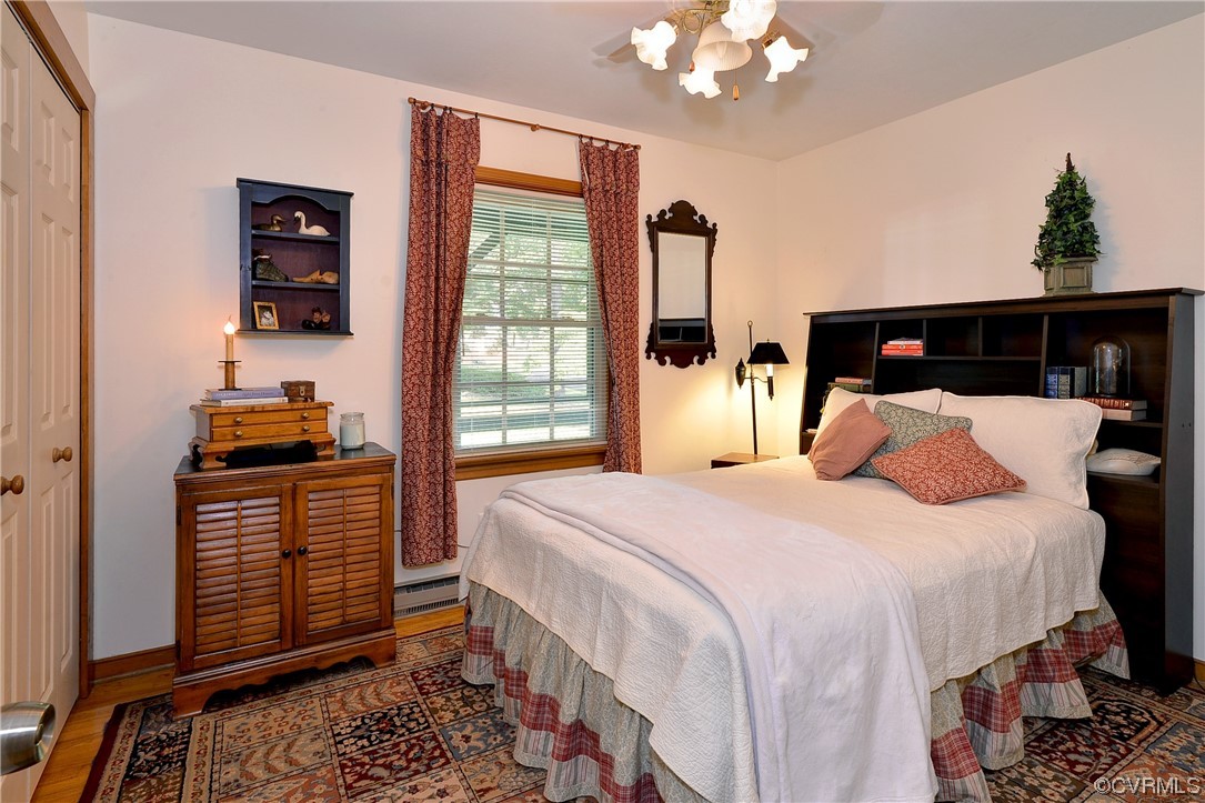 7317 Creighton Road Mechanicsville, VA 23111 - Photo 25 of 46 a bedroom with a bed and a chandelier