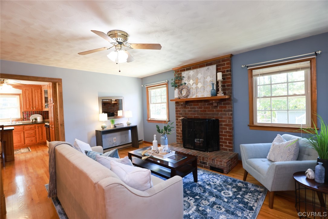 7317 Creighton Road Mechanicsville, VA 23111 - Photo 10 of 46 a living room with furniture and a fireplace