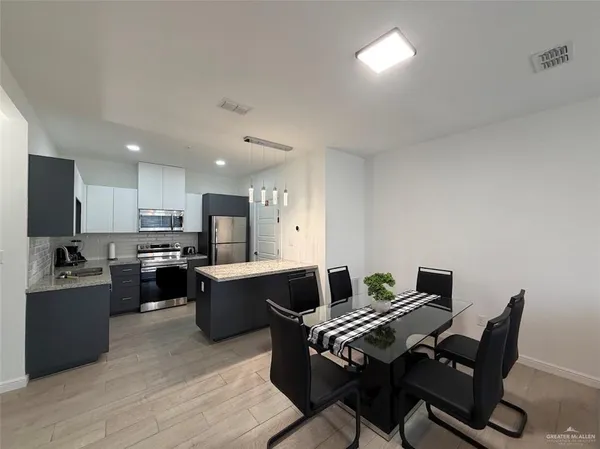 a view of a dining room with furniture and wooden floor