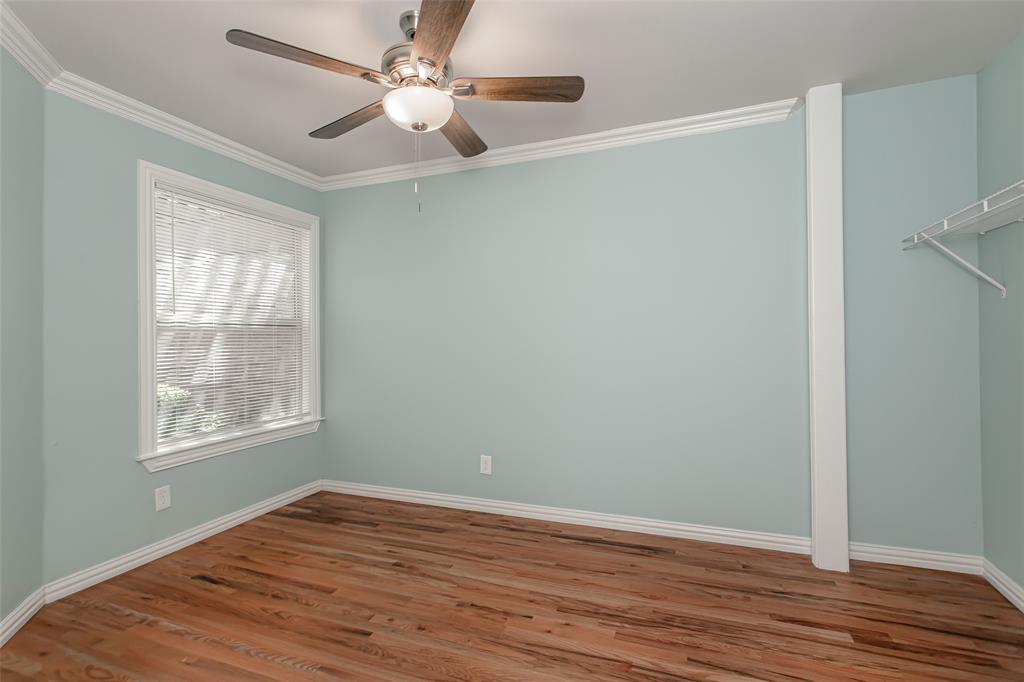 4139 Rosser Square Dallas, TX 75244 - Photo 19 of 34 Charming secondary bedroom featuring rich hardwood floors, soft designer paint, crown molding, and abundant natural light.