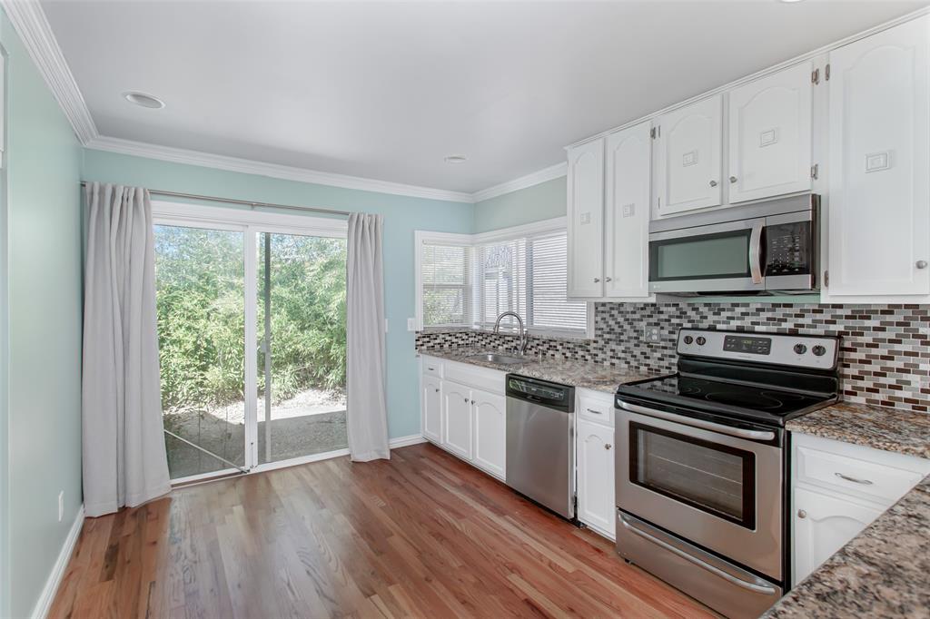4139 Rosser Square Dallas, TX 75244 - Photo 3 of 34 Spacious kitchen with a sliding glass door that fills the space with natural light and provides access to the private outdoor patio.