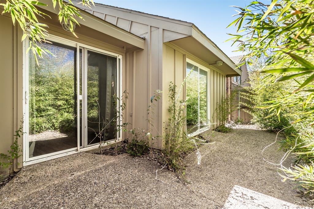 4139 Rosser Square Dallas, TX 75244 - Photo 4 of 34 Private outdoor patio with sliding glass door access, offering a peaceful setting for relaxing or entertaining.