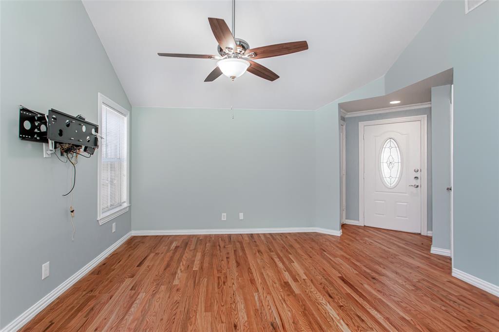 4139 Rosser Square Dallas, TX 75244 - Photo 9 of 34 Bright and inviting living room featuring vaulted ceilings, rich hardwood floors, and abundant natural light for a warm and welcoming atmosphere.