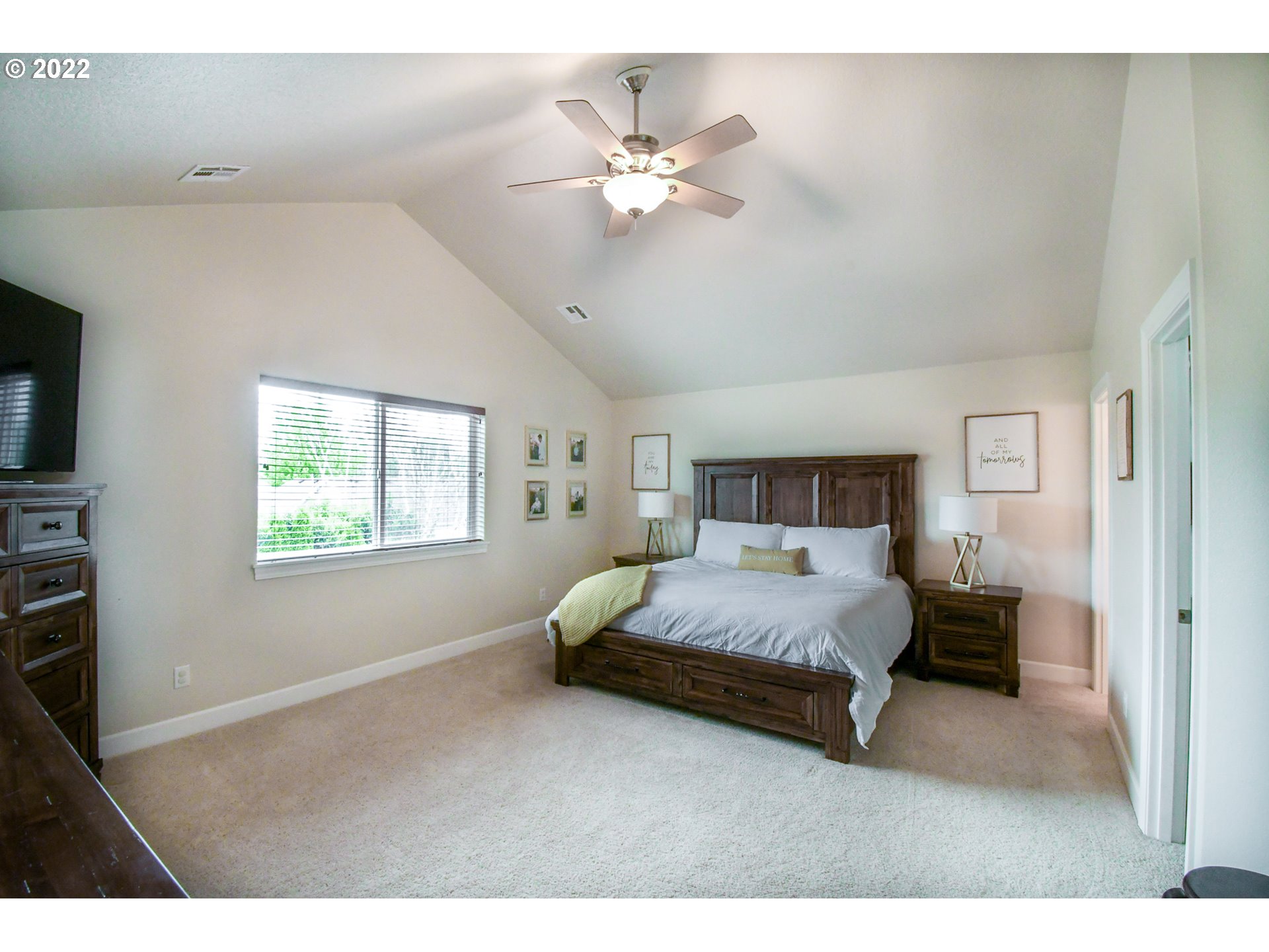 901 T Street Springfield, OR 97477 - Photo 11 of 29 a bedroom with a large bed and a chandelier