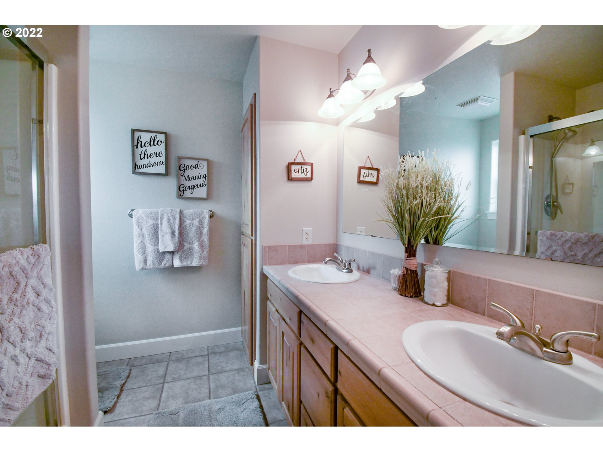 901 T Street Springfield, OR 97477 - Photo 13 of 29 a bathroom with a granite countertop sink a large mirror and a shower
