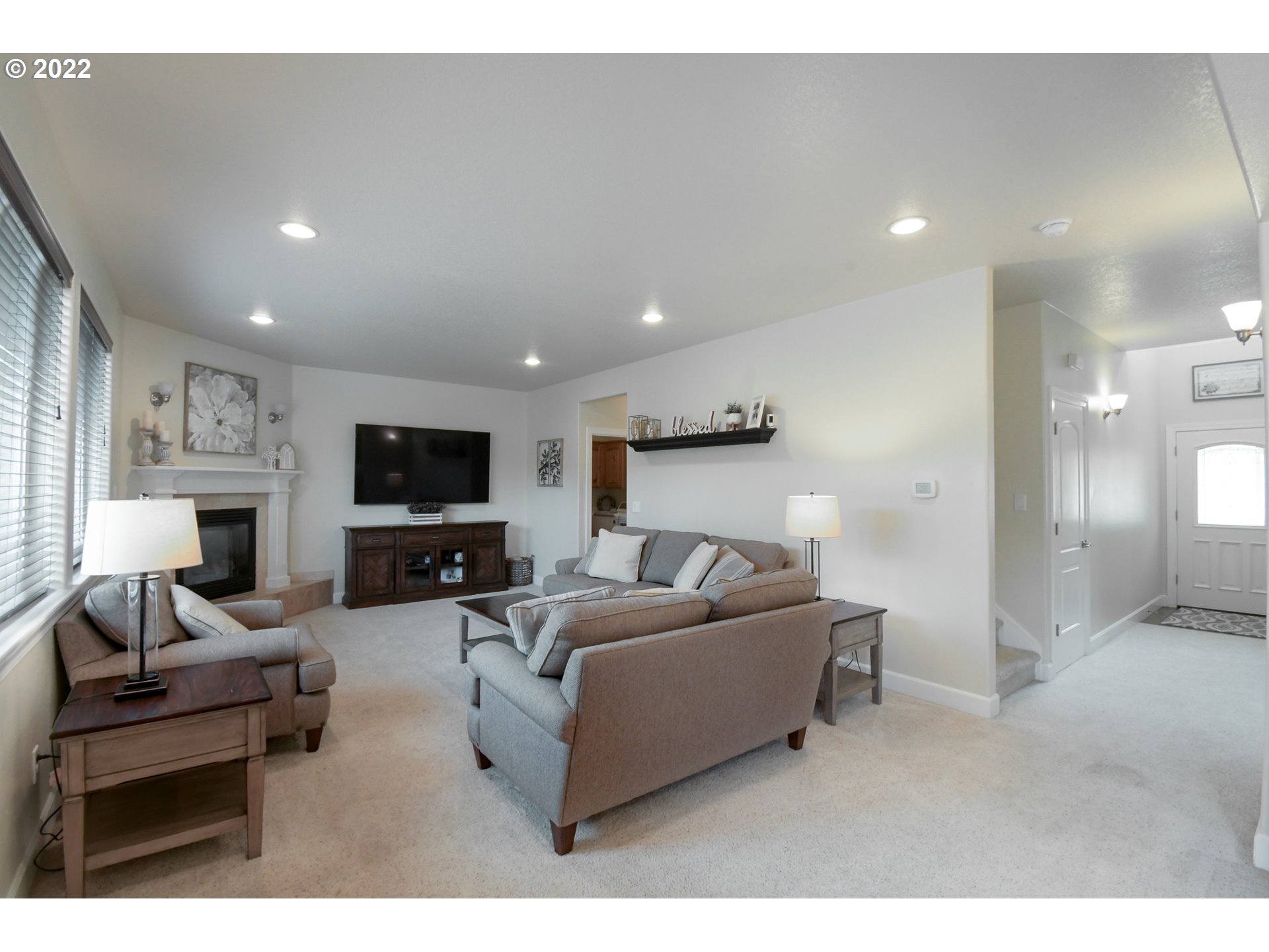 901 T Street Springfield, OR 97477 - Photo 2 of 29 a living room with furniture a flat screen tv and a fireplace