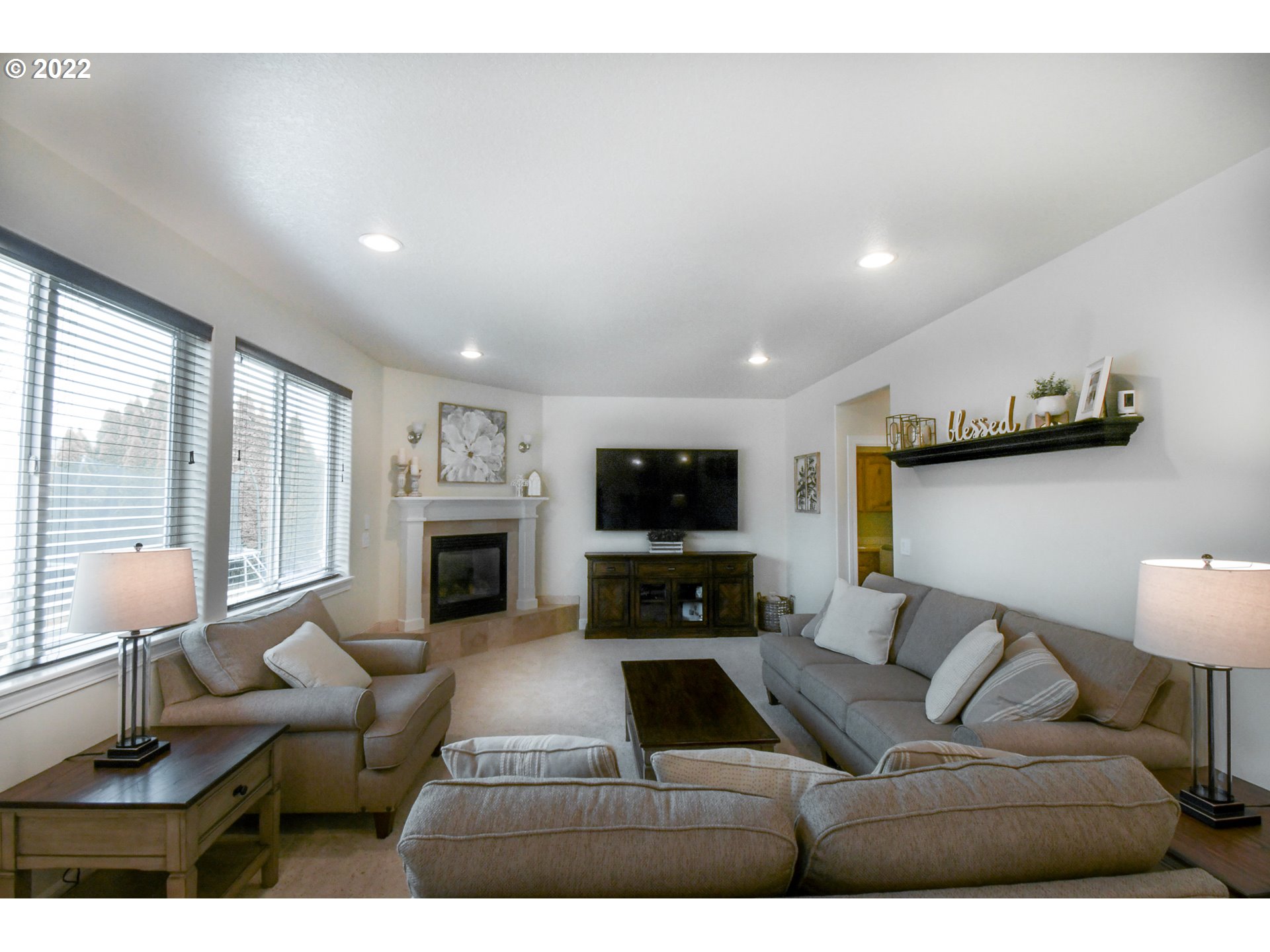 901 T Street Springfield, OR 97477 - Photo 3 of 29 a living room with furniture a fireplace and a flat screen tv