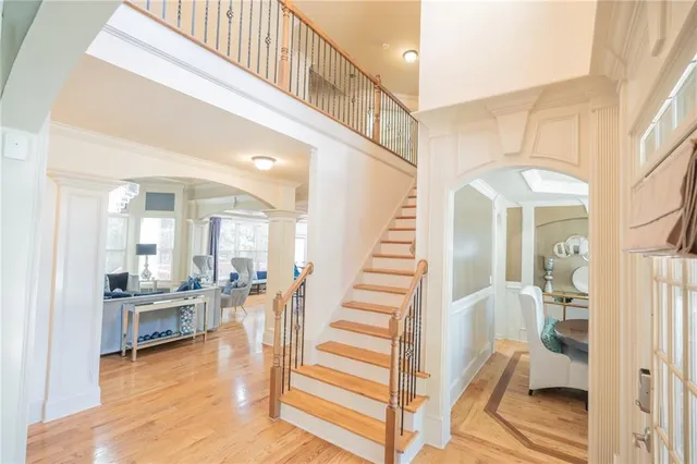 a view of entryway and hall with wooden floor