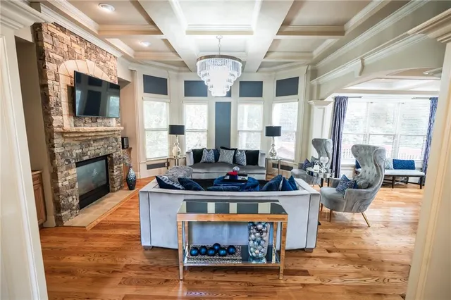 a living room with furniture a fireplace and a flat screen tv