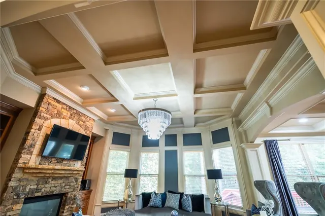 a dining hall with stainless steel appliances kitchen island granite countertop a table chairs and a wooden floor