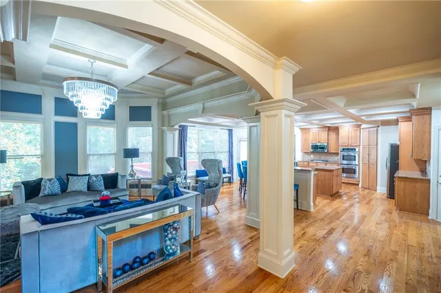 a view of a dining room with furniture wooden floor and chandelier