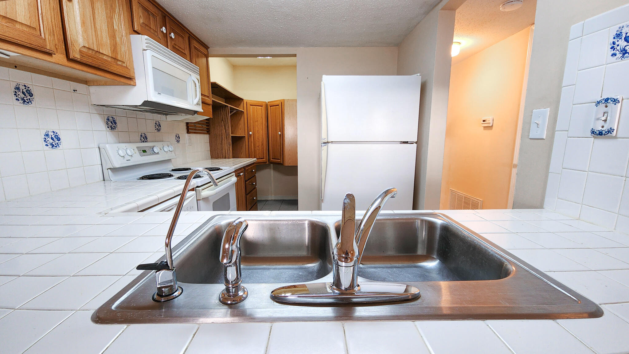 145 4th Avenue, Unit B3 Shalimar, FL 32579 - Photo 13 of 28 a view of a kitchen with a sink and a refrigerator