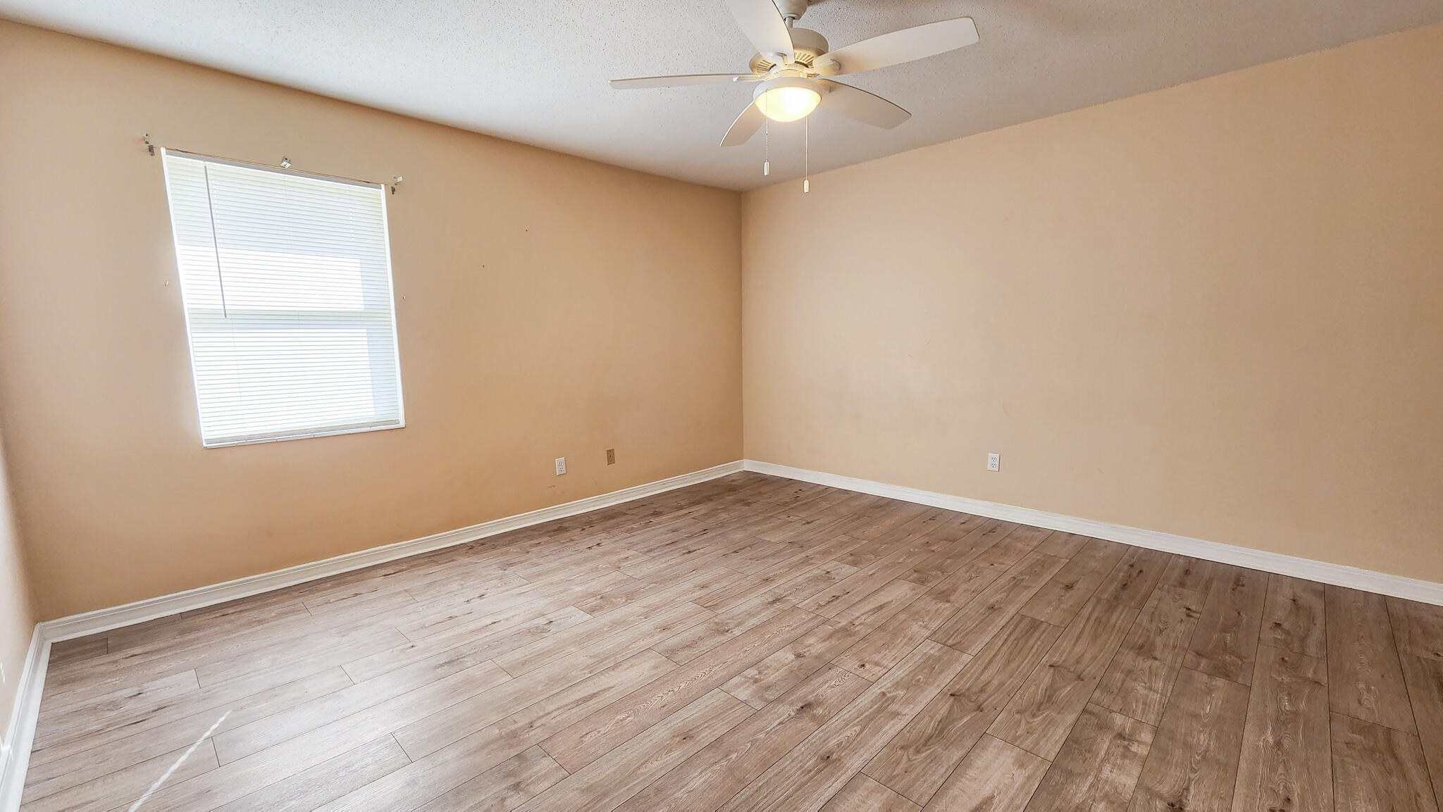 145 4th Avenue, Unit B3 Shalimar, FL 32579 - Photo 26 of 28 an empty room with wooden floor and windows