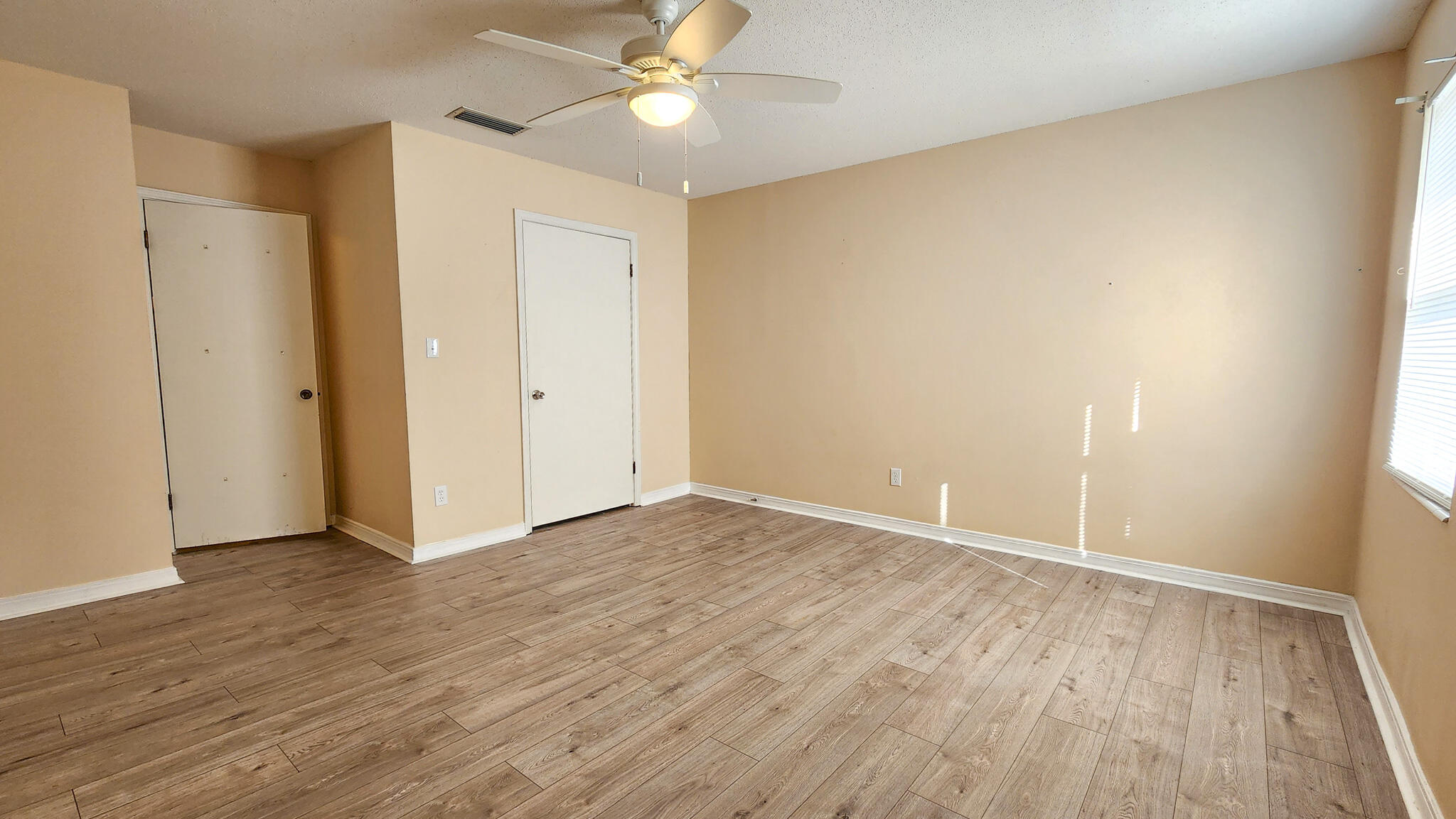 145 4th Avenue, Unit B3 Shalimar, FL 32579 - Photo 28 of 28 an empty room with wooden floor and windows