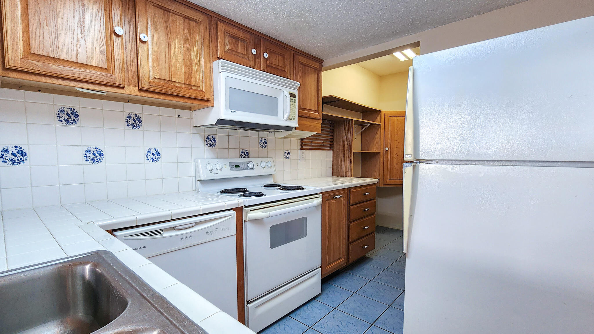 145 4th Avenue, Unit B3 Shalimar, FL 32579 - Photo 9 of 28 a kitchen with stainless steel appliances granite countertop a refrigerator and a stove top oven