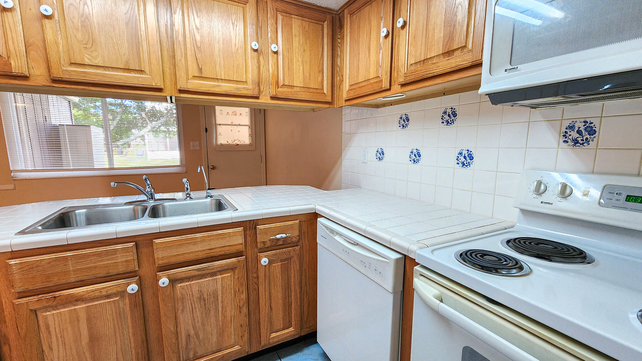 145 4th Avenue, Unit B3 Shalimar, FL 32579 - Photo 10 of 28 a kitchen with a sink a stove and cabinets