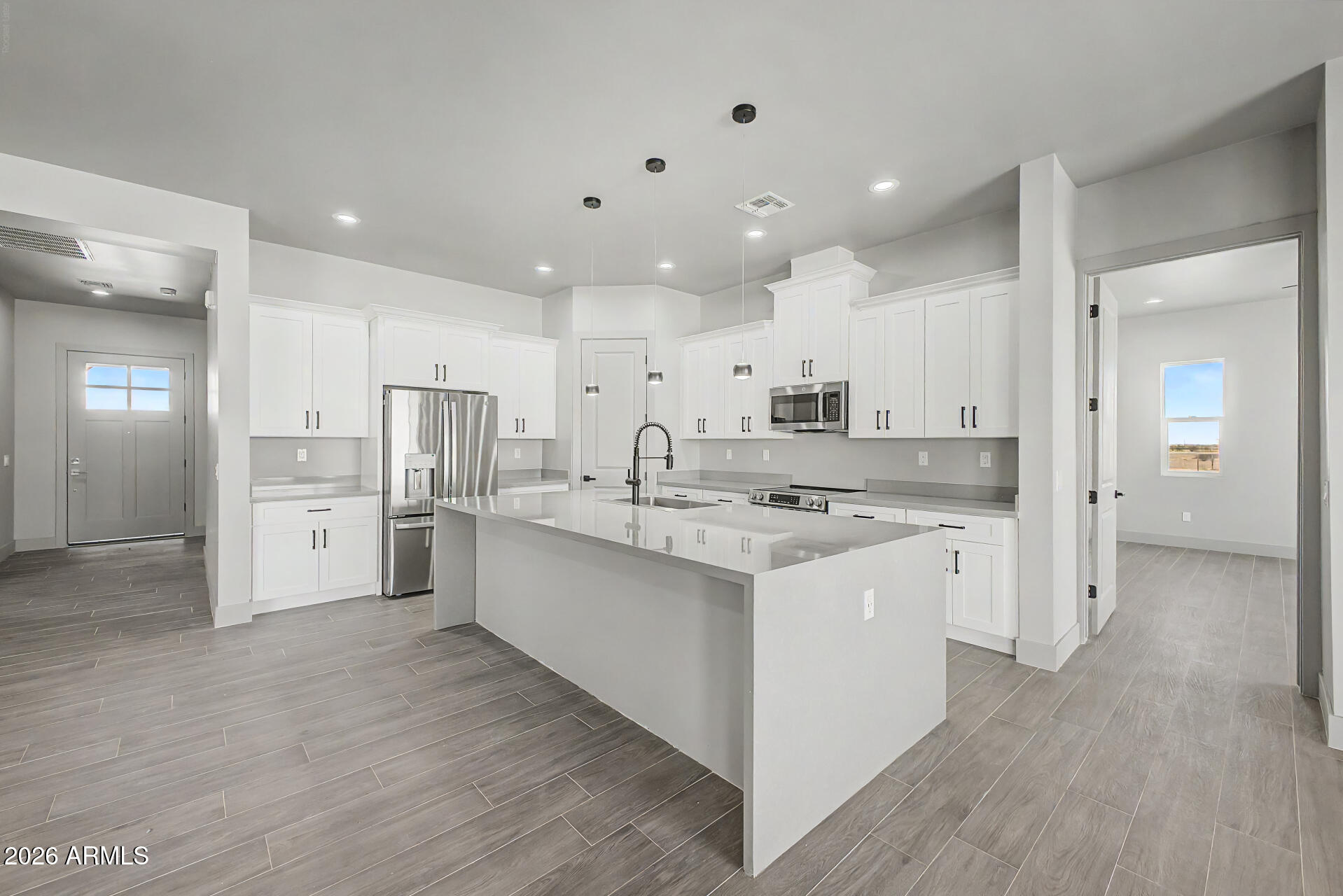 40461 West Robles Road Stanfield, AZ 85172 - Photo 27 of 54 a large kitchen with a lot of counter space and stainless steel appliances
