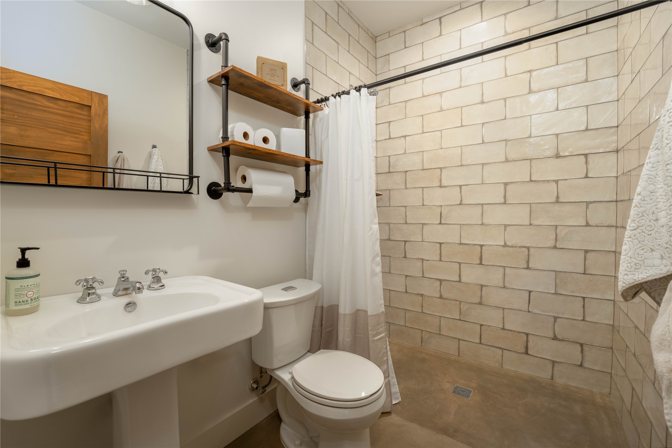 4707 Guenther Road La Grange, TX 78945 - Photo 19 of 26 a bathroom with a sink a toilet and shower curtain