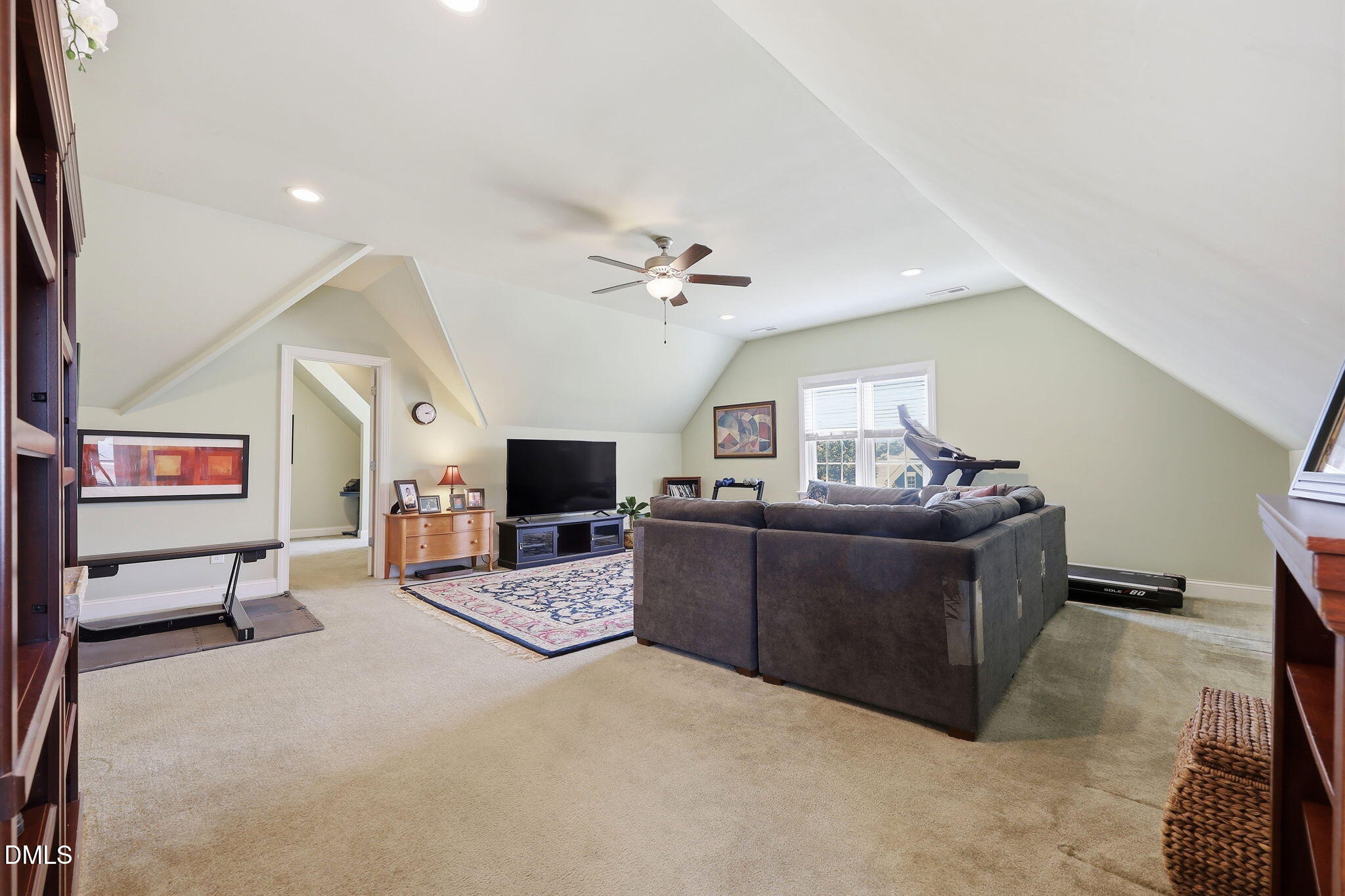 7040 Dayton Ridge Drive Apex, NC 27539 - Photo 25 of 38 a living room with furniture and a flat screen tv