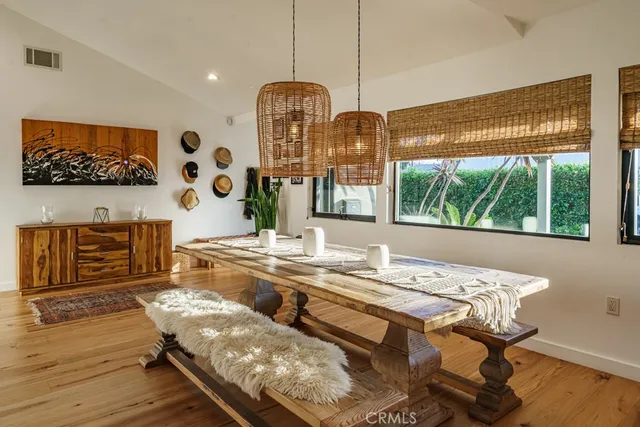a living room with furniture chandelier and a large window