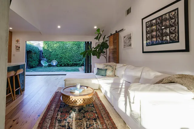 a bed room with a bed mirror and a window