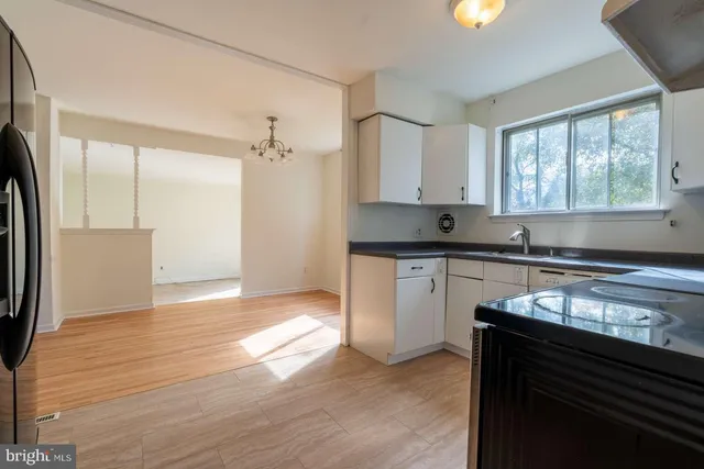 a kitchen with granite countertop a sink cabinets and a window