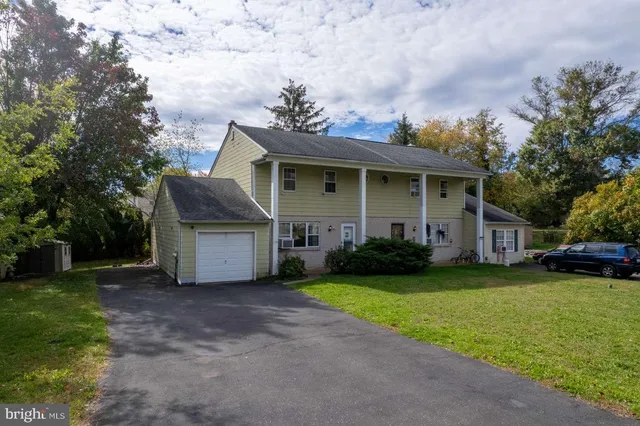 a view of a house with a yard and sitting area