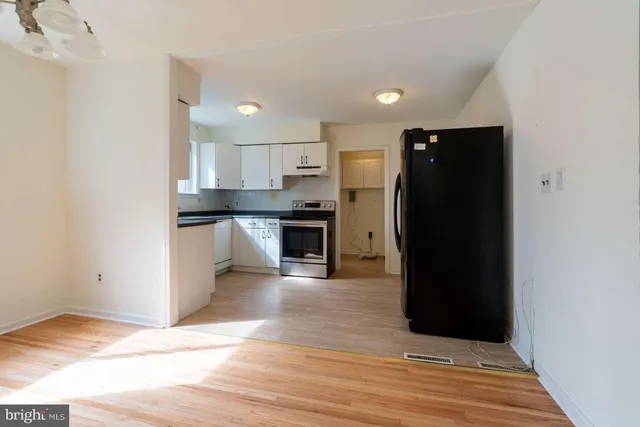 a view of a kitchen with a sink and a refrigerator