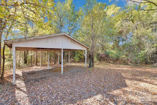 a backyard of a house with barbeque oven
