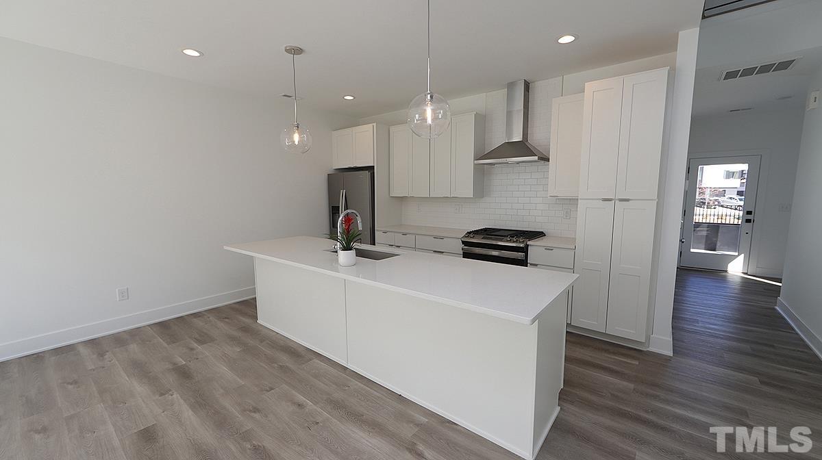 2204-101 St Raleigh Nc 27610, Unit 101 Raleigh, NC 27610 - Photo 3 of 18 a view of kitchen with wooden floor