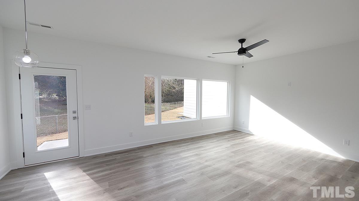 2204-101 St Raleigh Nc 27610, Unit 101 Raleigh, NC 27610 - Photo 8 of 18 a view of empty room with wooden floor and fan