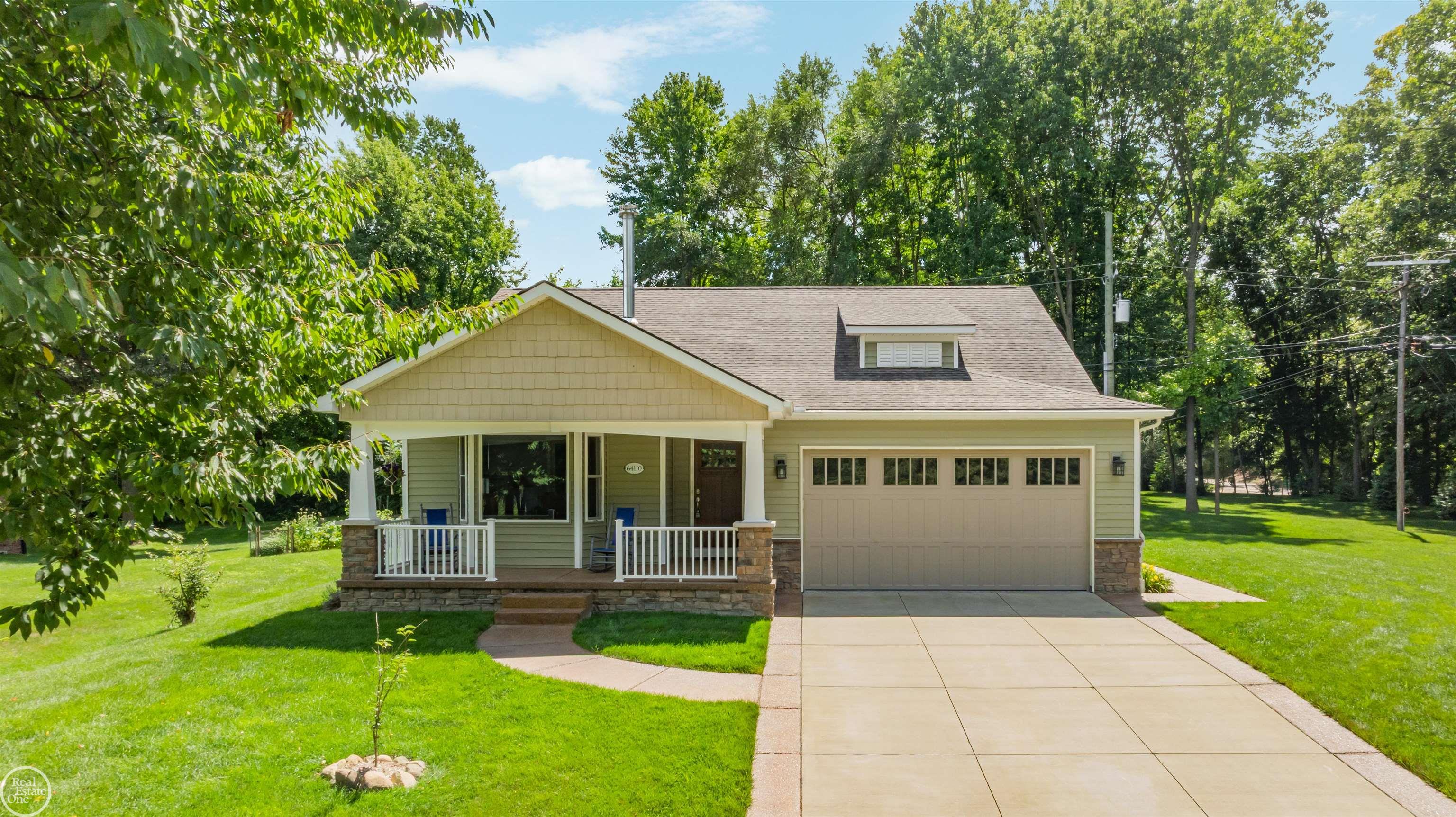 Vinyl siding and trim; exposed aggregate driveway ribbons