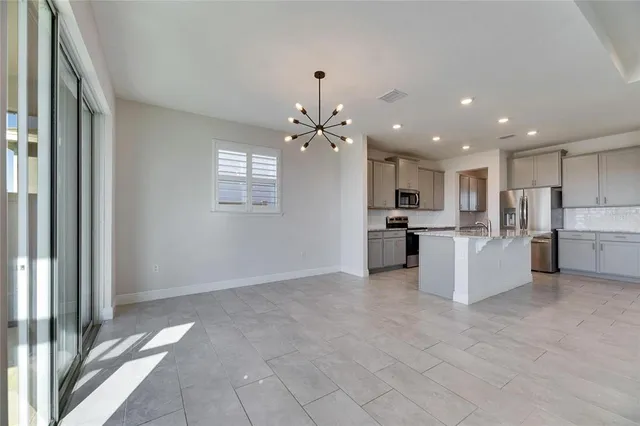 a view of kitchen with sink and refrigerator