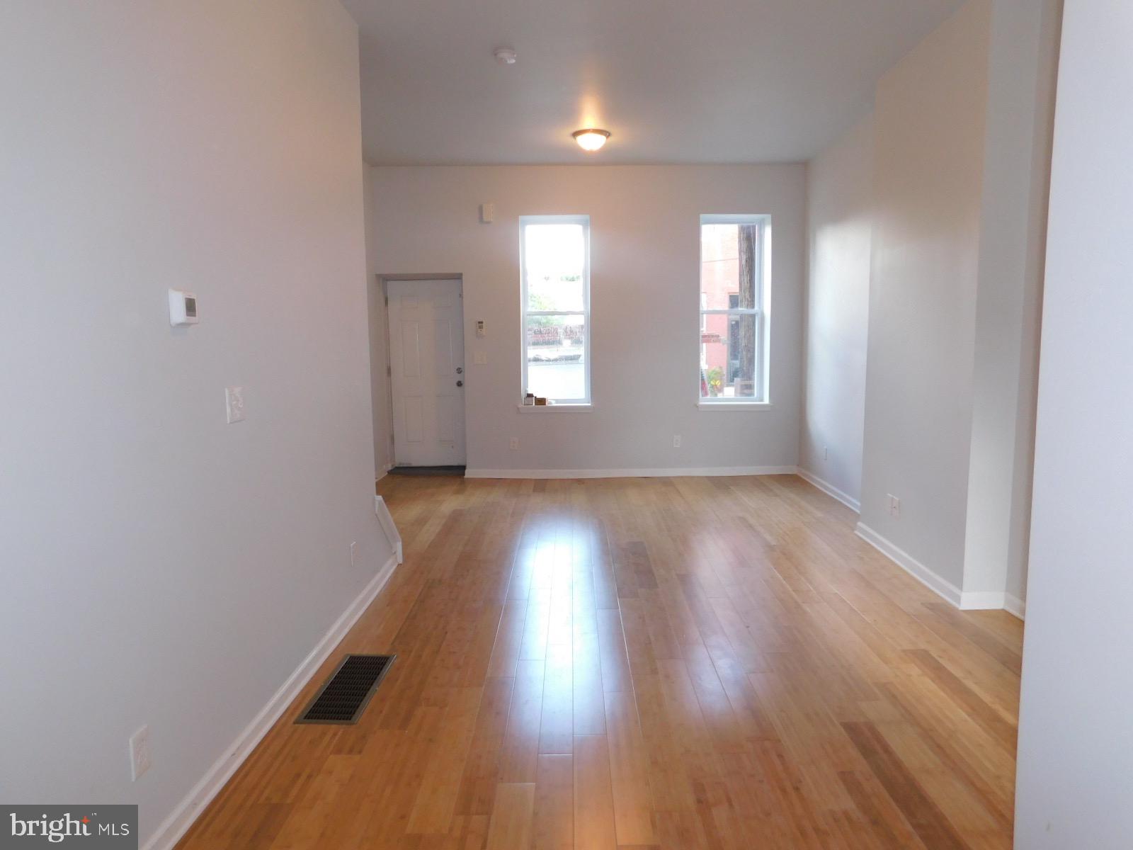 2238 Master Street Philadelphia, PA 19121 - Photo 3 of 24 an empty room with wooden floor and windows