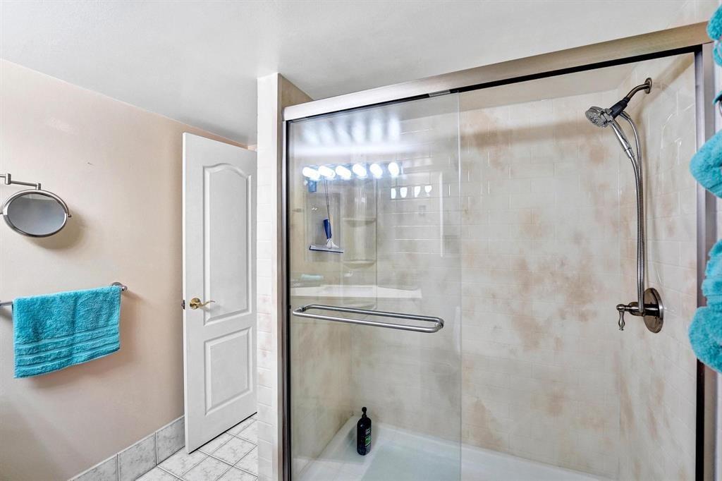 100 Golden Isles Drive, Unit 815 Hallandale Beach, FL 33009 - Photo 12 of 42 a bathroom with a glass shower door