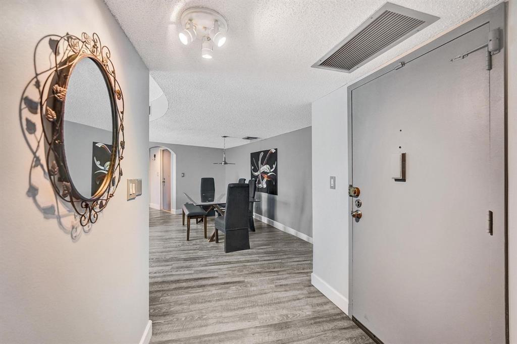 100 Golden Isles Drive, Unit 815 Hallandale Beach, FL 33009 - Photo 17 of 42 a view of a livingroom from a hallway