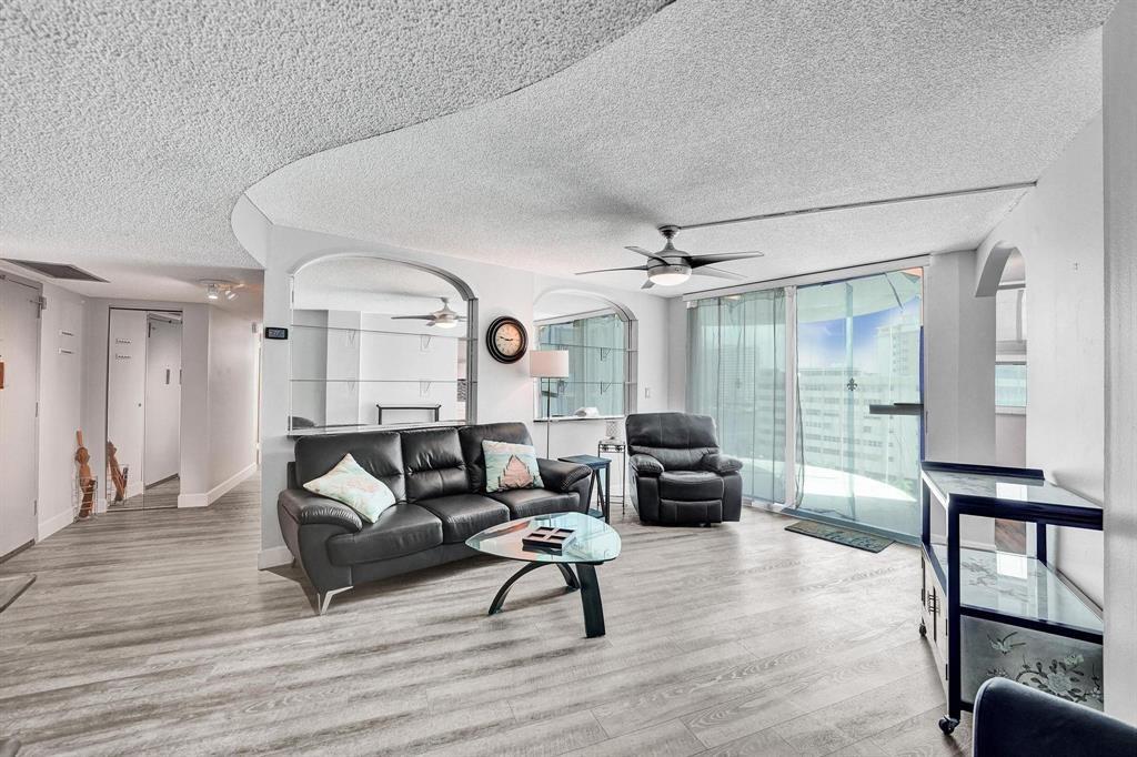 100 Golden Isles Drive, Unit 815 Hallandale Beach, FL 33009 - Photo 20 of 42 a living room with furniture and a wooden floor